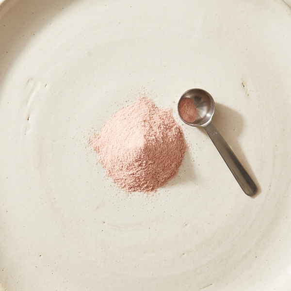 Close macro of the pink lemonade creatine powder and scoop